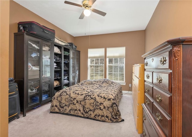 bedroom with light colored carpet, a ceiling fan, and access to outside