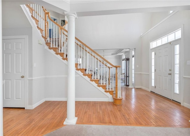 foyer with wood-type flooring and ornate columns