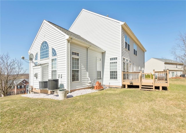 rear view of property featuring a deck and a yard