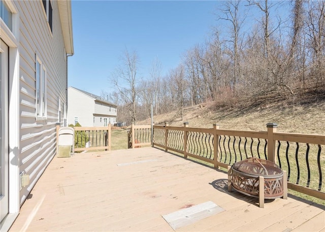 wooden deck featuring an outdoor fire pit