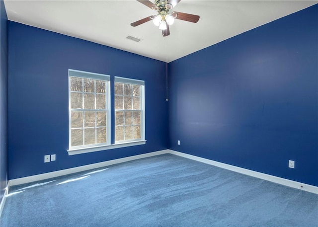 empty room featuring baseboards, visible vents, and carpet floors