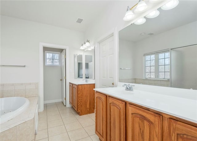 full bathroom with tile patterned floors, visible vents, a healthy amount of sunlight, and a sink