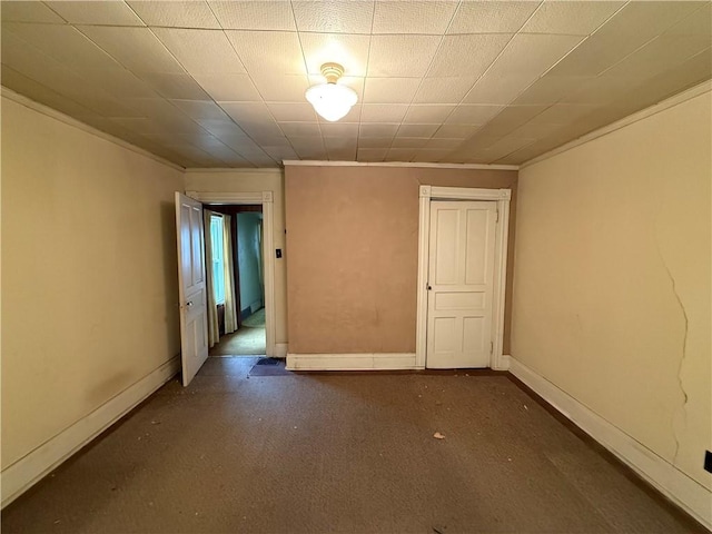 unfurnished room featuring baseboards and ornamental molding