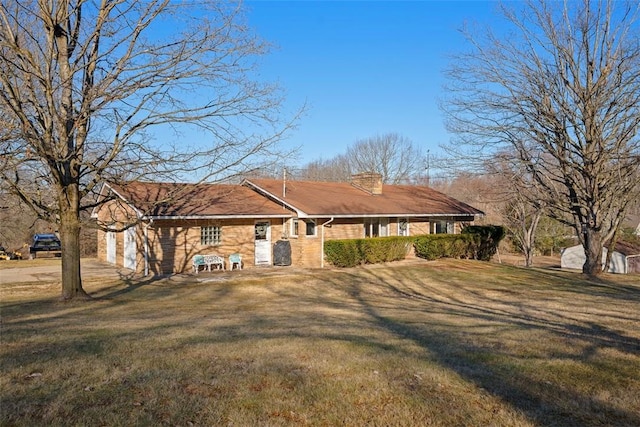 view of front of home featuring a chimney and a front yard