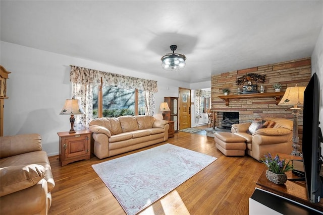 living area with a fireplace and light wood-style floors