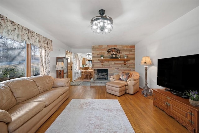 living room featuring light wood-style flooring and a fireplace