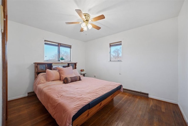 bedroom featuring ceiling fan, baseboards, wood-type flooring, and a baseboard radiator