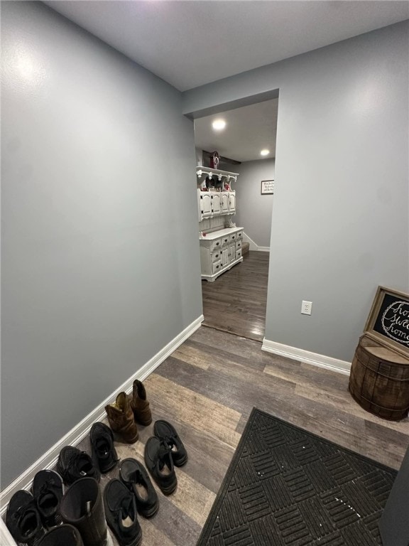 exercise area with baseboards and dark wood-style flooring