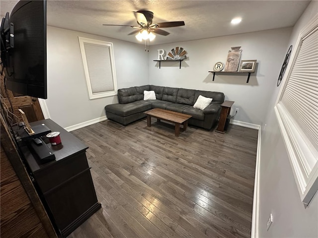 living room featuring dark wood-type flooring, recessed lighting, a ceiling fan, and baseboards