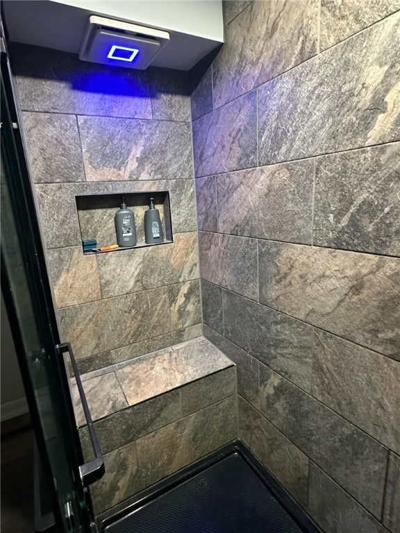 full bath featuring a tile shower