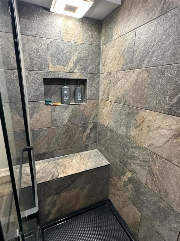 full bath featuring a tile shower