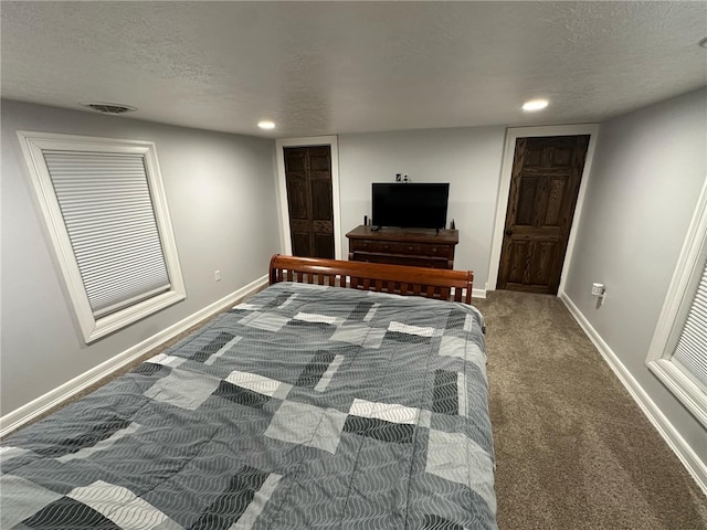 bedroom featuring baseboards, a textured ceiling, and carpet flooring