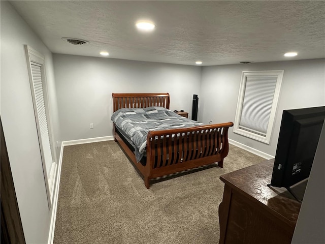 carpeted bedroom with recessed lighting, visible vents, baseboards, and a textured ceiling