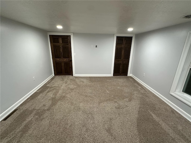 interior space with visible vents, baseboards, and a textured ceiling