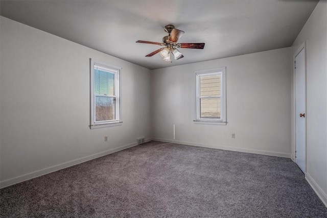 empty room featuring baseboards, visible vents, a ceiling fan, and carpet