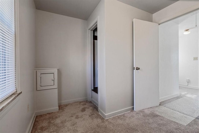 unfurnished bedroom with carpet flooring and baseboards