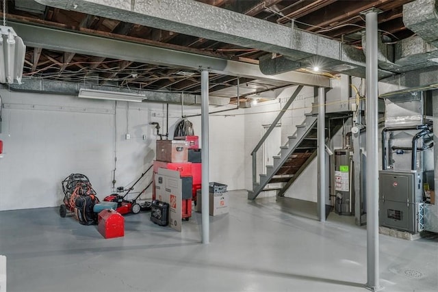 unfinished basement with heating unit, stairway, and gas water heater