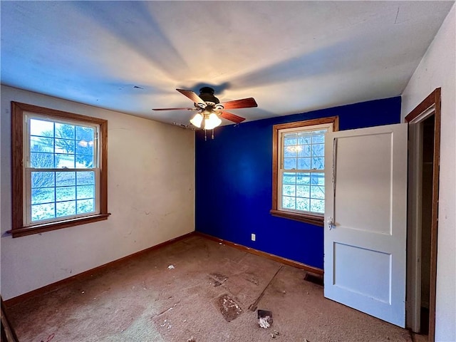 unfurnished bedroom with multiple windows, baseboards, and ceiling fan