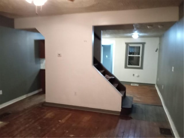 interior space featuring wood finished floors and baseboards