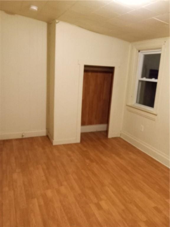 unfurnished room featuring light wood-style flooring and baseboards