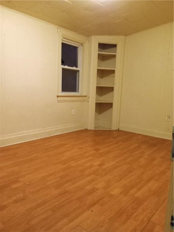 spare room with light wood-type flooring and baseboards