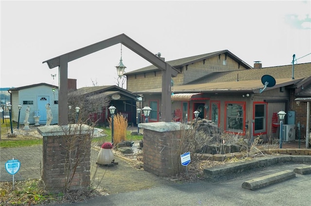 exterior space with ac unit, an outdoor structure, and a shed