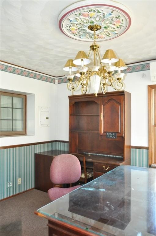 carpeted dining space featuring wallpapered walls, a notable chandelier, and wainscoting