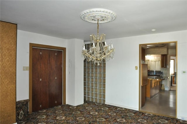 dining space with an inviting chandelier