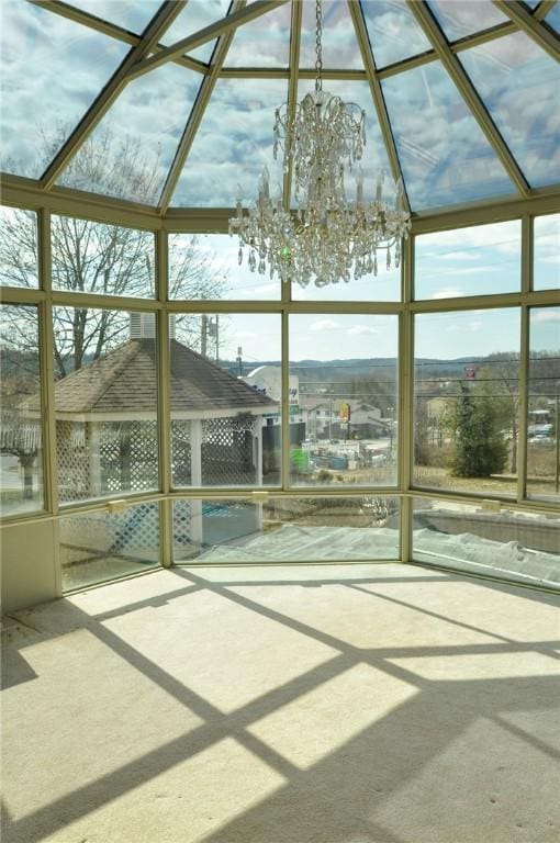 unfurnished sunroom featuring an inviting chandelier