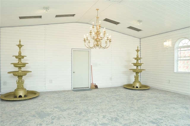 spare room with carpet flooring and vaulted ceiling