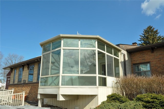 view of side of property featuring a sunroom