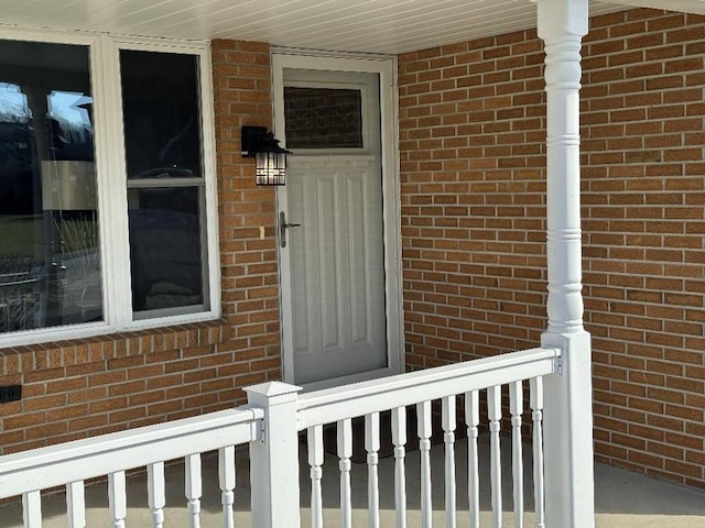 doorway to property featuring brick siding