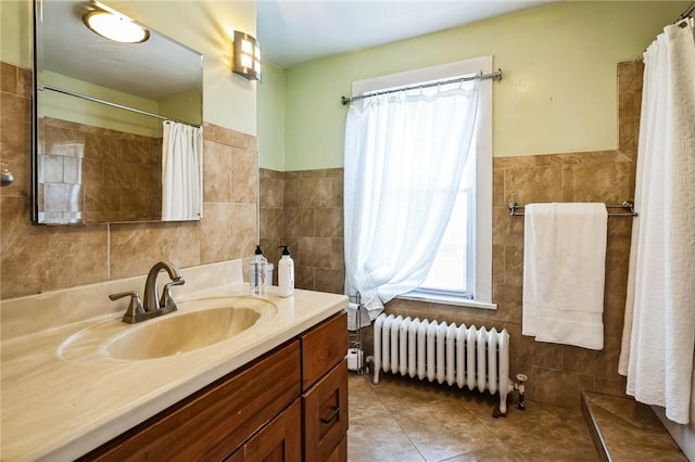 bathroom featuring vanity, tile walls, radiator, and tile patterned flooring