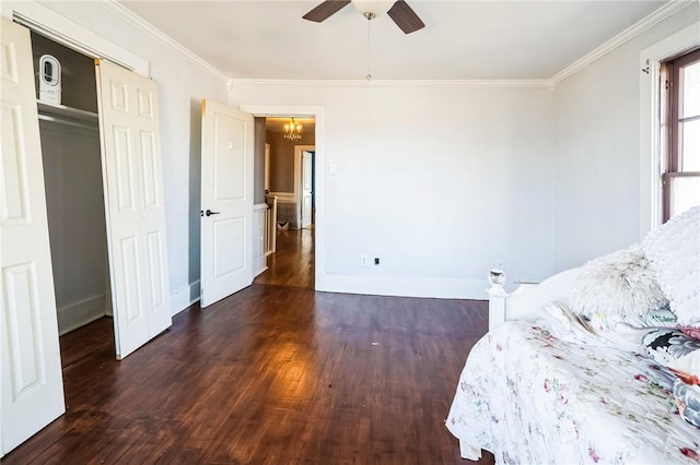 unfurnished bedroom with ceiling fan, wood finished floors, baseboards, and ornamental molding