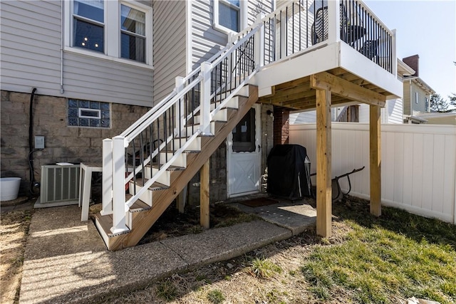 view of patio with grilling area, central AC unit, stairs, and fence