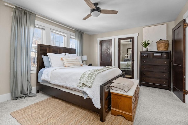 carpeted bedroom featuring a ceiling fan and baseboards