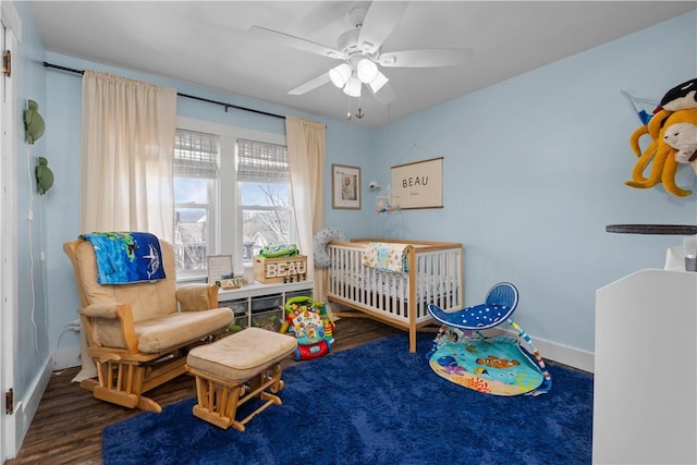 bedroom with ceiling fan, baseboards, and wood finished floors