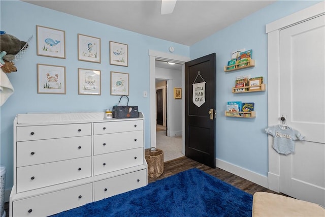 bedroom featuring baseboards, ceiling fan, and dark wood-style flooring