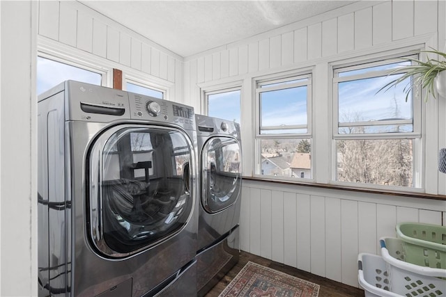 laundry area featuring separate washer and dryer, dark wood-style flooring, and laundry area