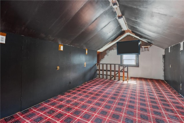 bonus room featuring carpet floors and vaulted ceiling