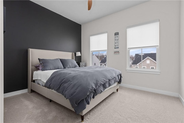 bedroom with baseboards, carpet floors, and a ceiling fan