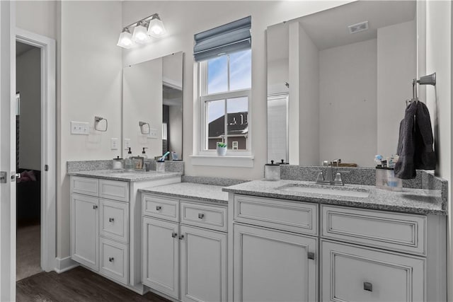 full bathroom with visible vents, wood finished floors, and vanity