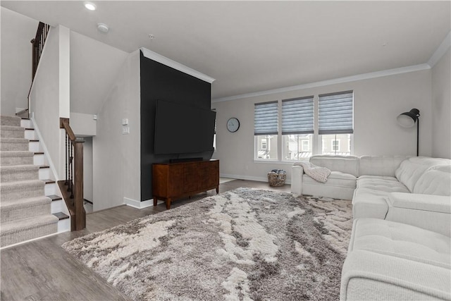 living room with stairway, ornamental molding, baseboards, and wood finished floors