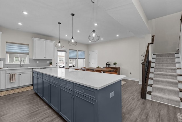 kitchen with light countertops, dark wood-style flooring, and white cabinetry