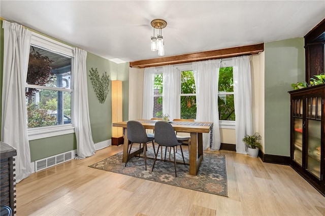 dining area with visible vents, plenty of natural light, and light wood-style flooring