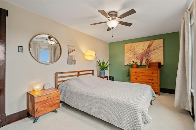 carpeted bedroom featuring a ceiling fan and baseboards