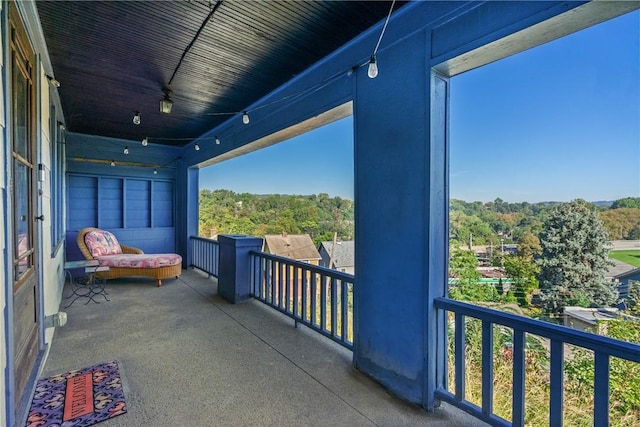 balcony featuring a forest view