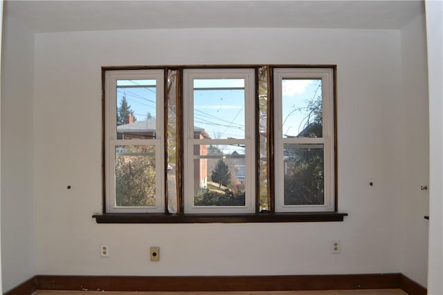 unfurnished room featuring baseboards