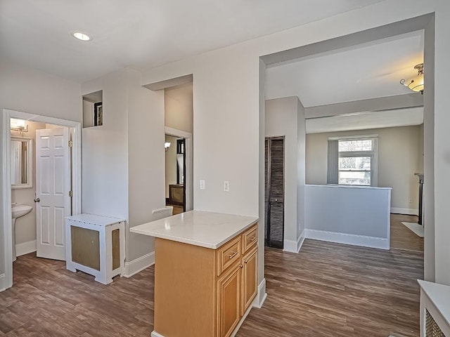 kitchen with dark wood-type flooring and baseboards