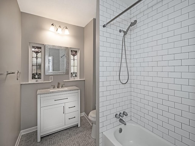 full bath with vanity, toilet, washtub / shower combination, and baseboards